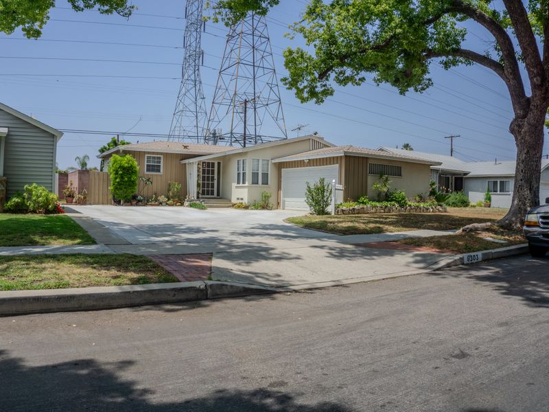 Mid-century homes on a leafy suburban street on a sunny day