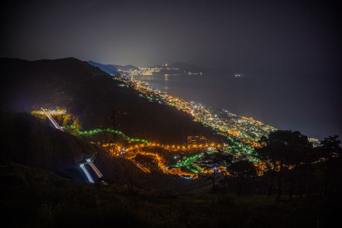 Free Stunning aerial night view of the illuminated Genova coastline in Liguria, Italy. Stock Photo