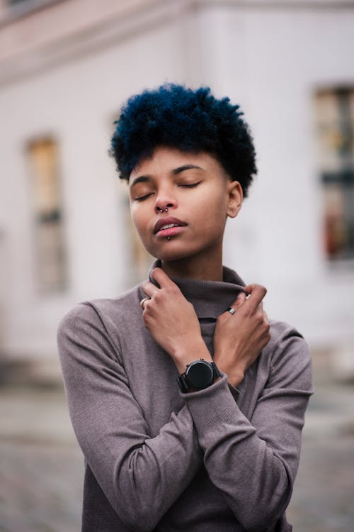 Portrait of Woman Standing with Arms Crossed and Eyes Closed