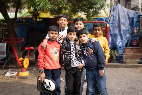 Free A group of boys standing together outdoors, showcasing friendship and youth in an urban setting. Stock Photo