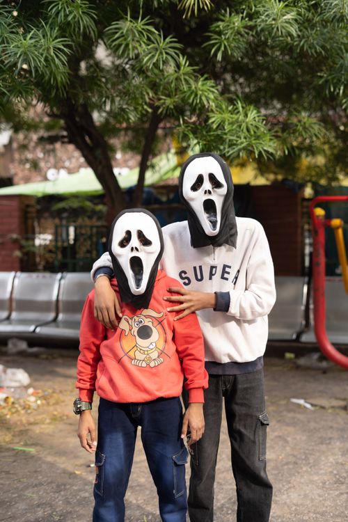 Free Two children in Halloween scream masks posing outdoors in Jammu. Stock Photo