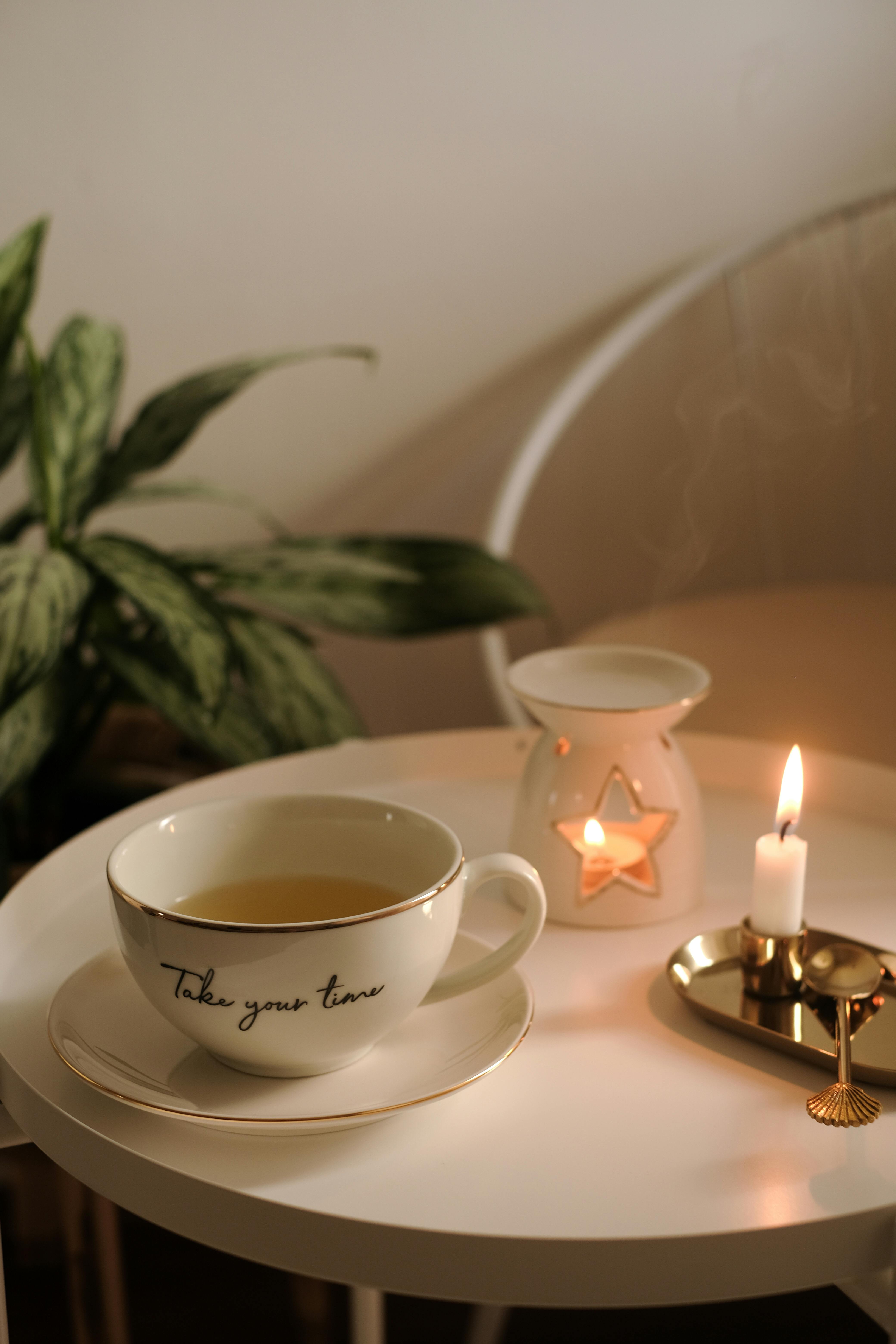 A comforting tea scene with a glowing candle and calming atmosphere.
