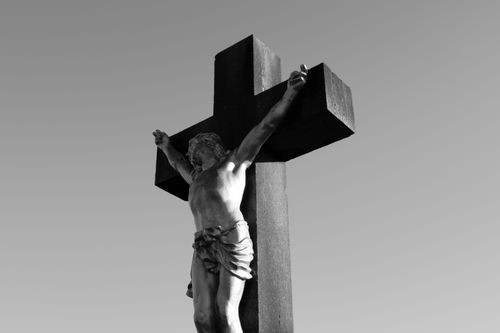 Free A black and white image of a Jesus crucifixion statue, symbolizing faith and sacrifice. Stock Photo