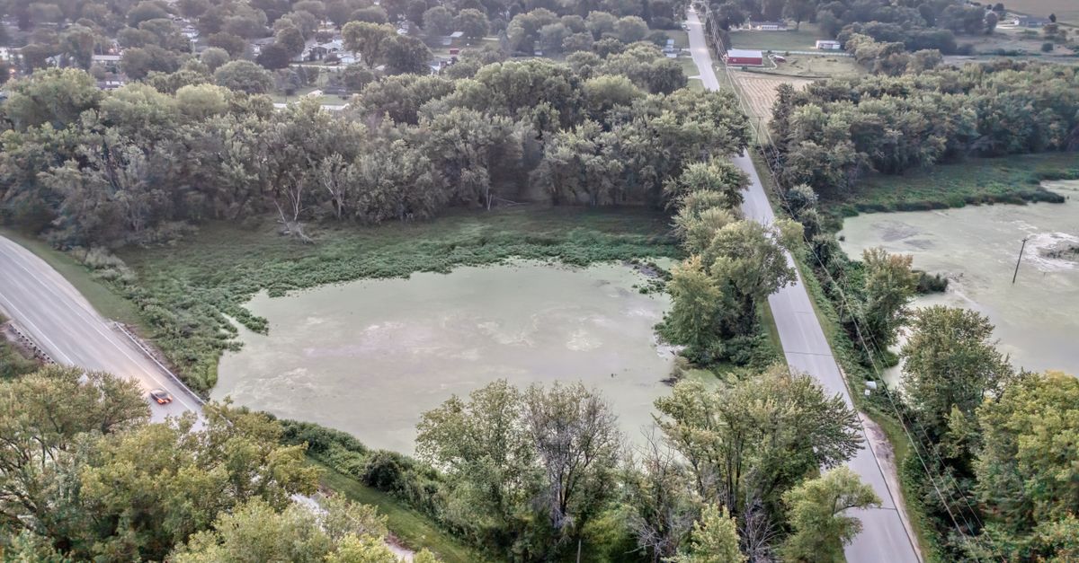 Drone image showcasing roads, lake, and forest in rural Wabasha, MN, during summer.