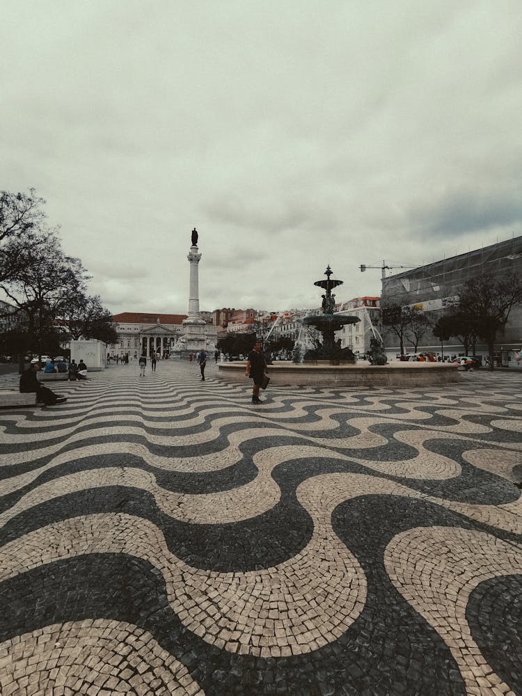 Sul Do Rossio Fountain And Column Of Pedro IV In A Square In Lisbon