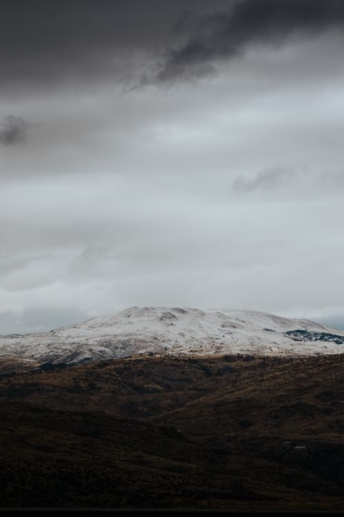 Free Dramatic landscape of snow-capped mountains under an overcast sky in Elmadağ, Ankara. Stock Photo