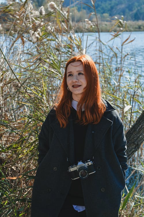 Smiling Redhead Woman with Camera