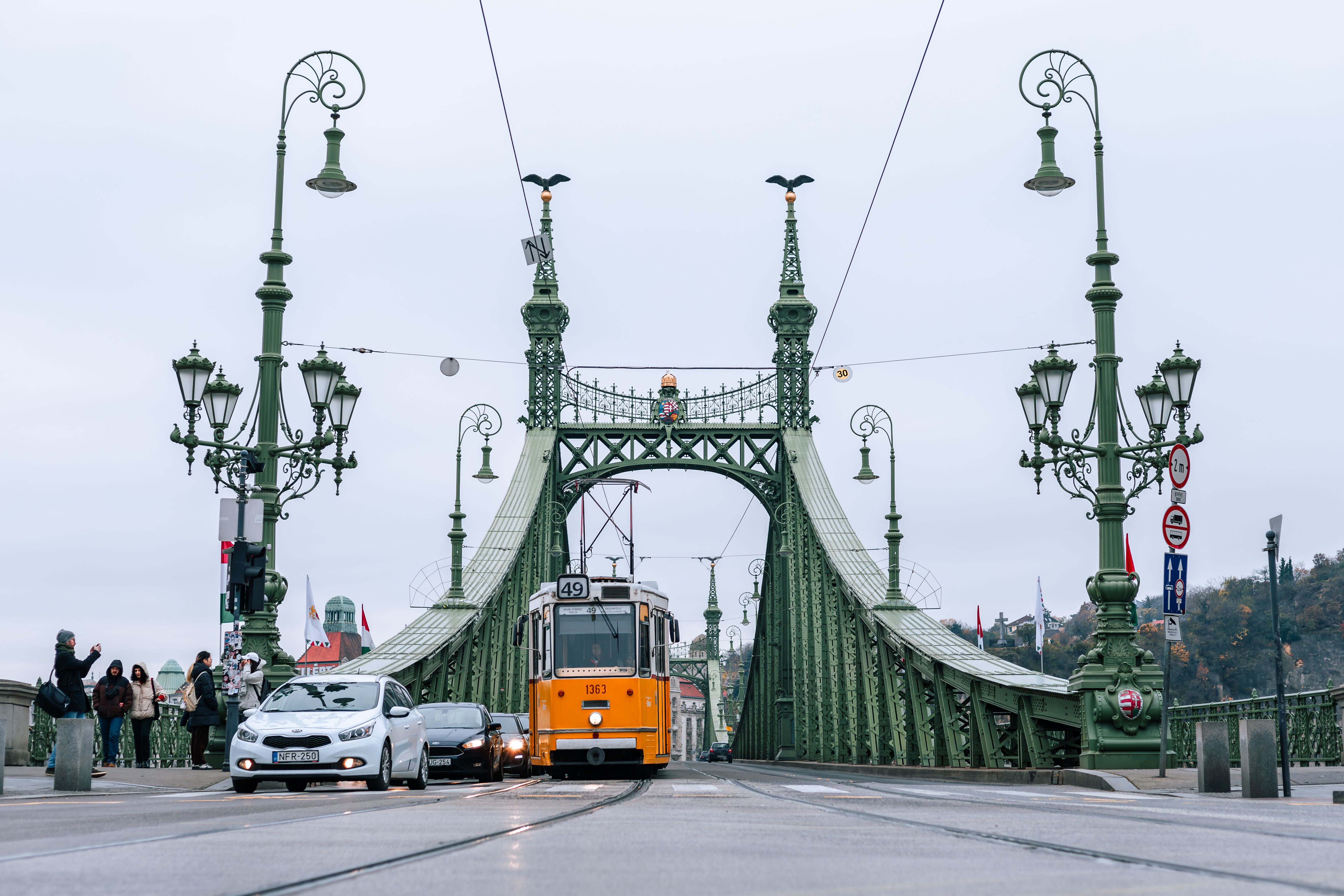 Tram crossing Liberty Bridge in Budapest capturing urban life and iconic architecture.