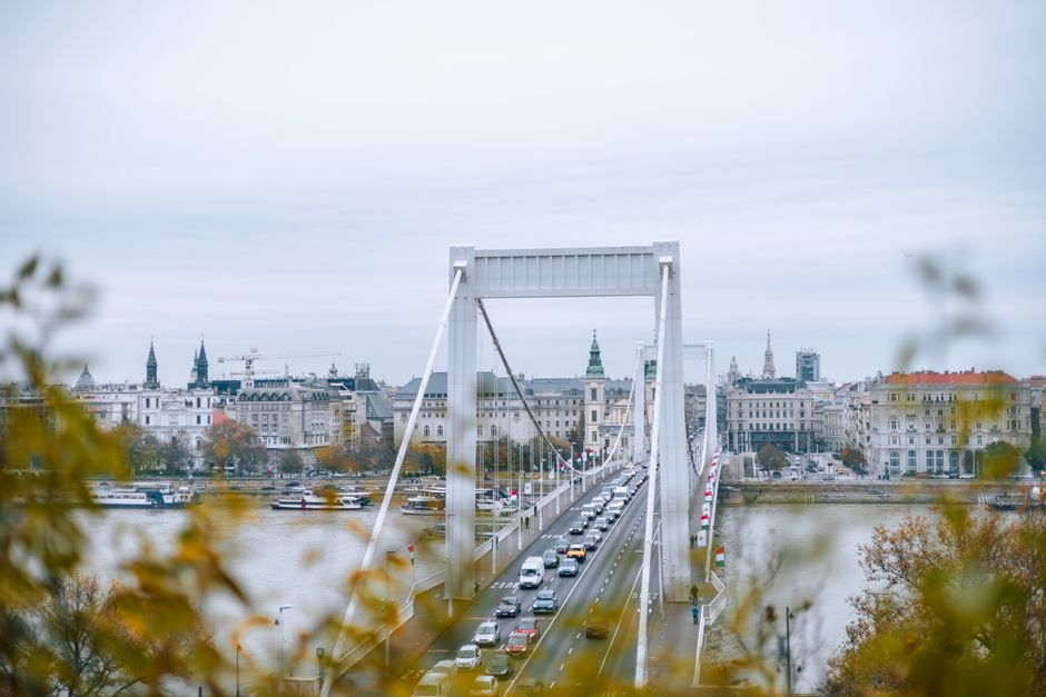 Stunning aerial view of Budapest's Erzsébet Bridge with urban skyline and river.