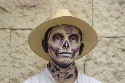 Portrait of a Man with Skull Makeup Wearing a Hat