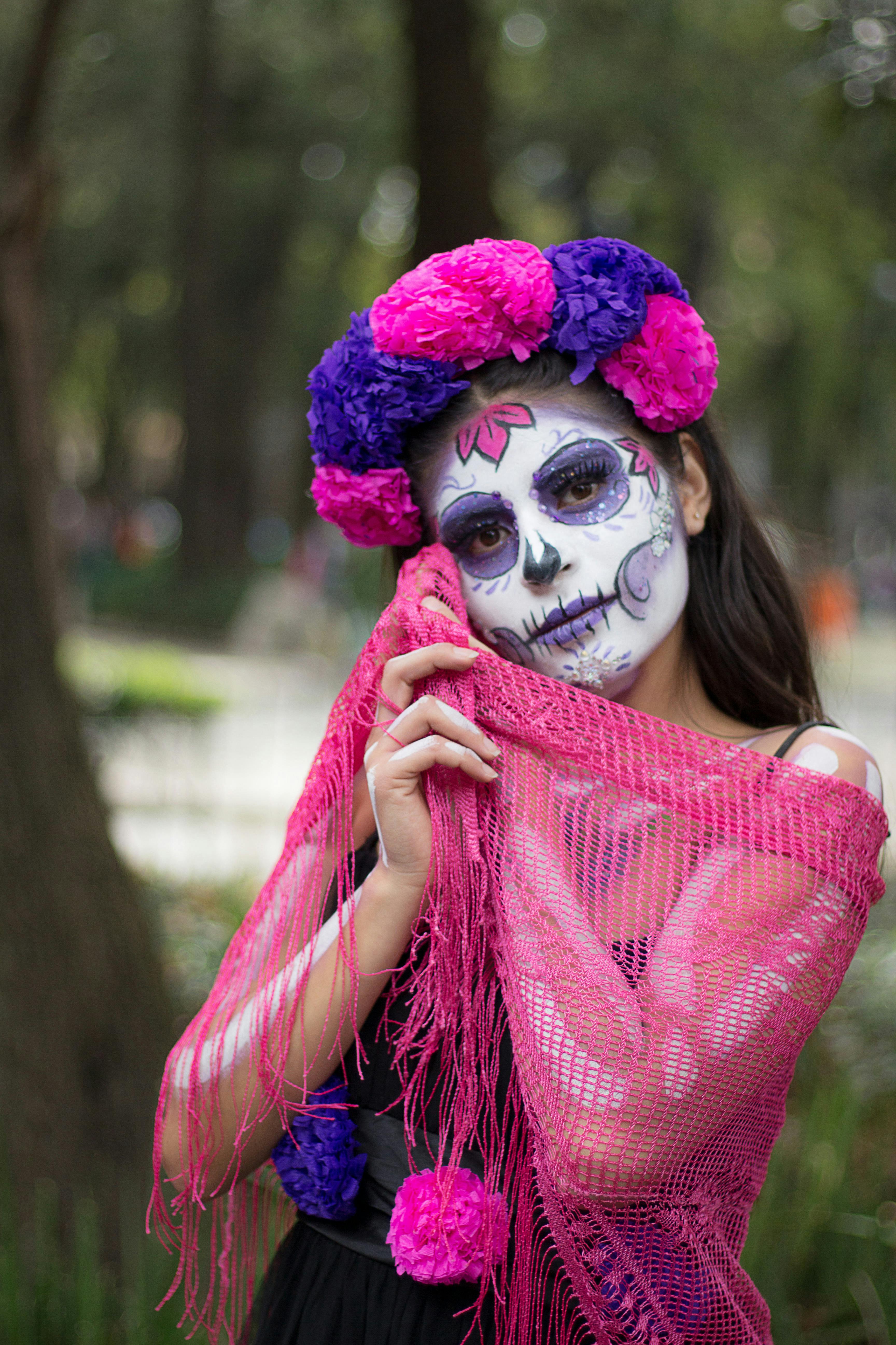 woman dressed as a catrina posing outside