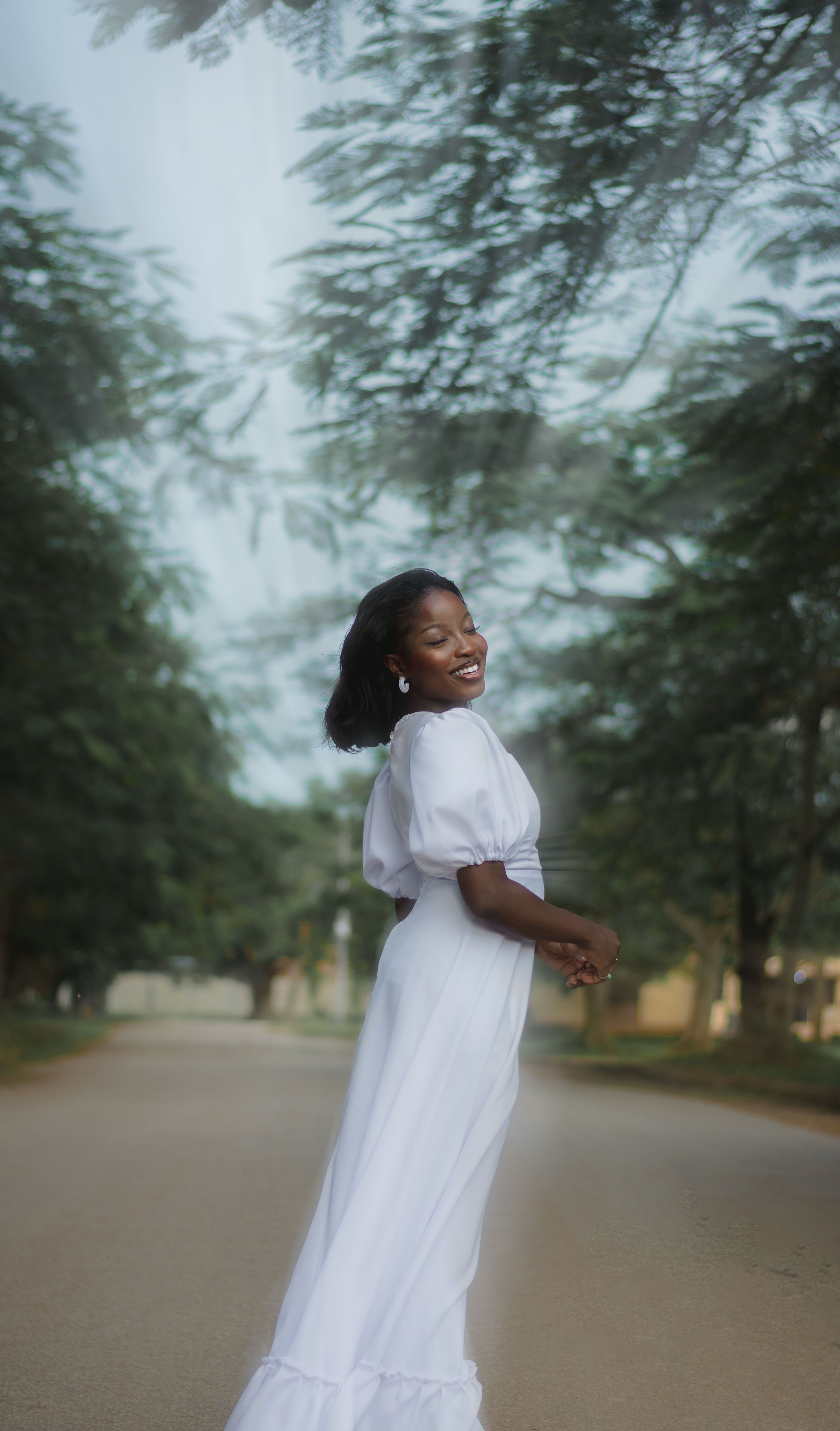 Smiling Brunette in Long White Dress · Free Stock Photo