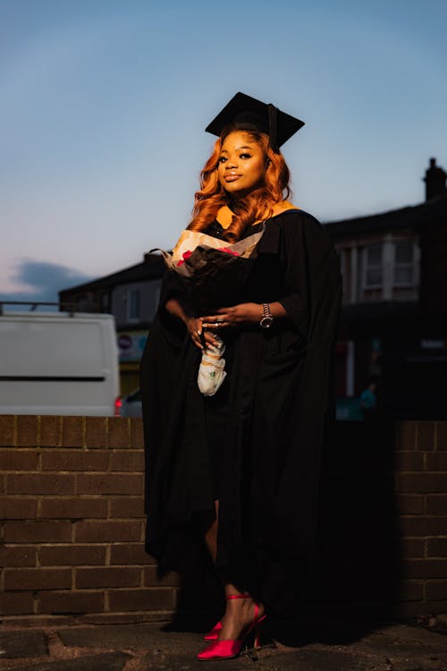 Young Woman in a Graduation Gown and Mortarboard 
