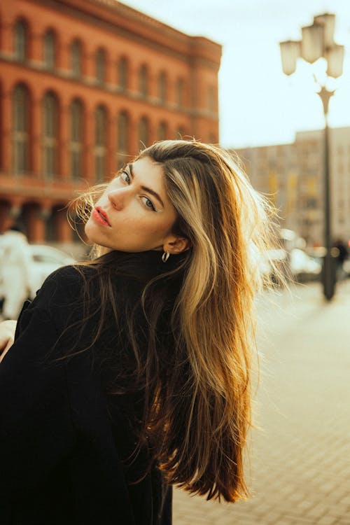 Beautiful Woman in Black Coat Posing on Street in Berlin, Germany