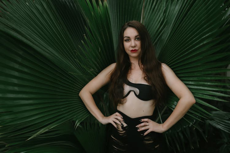 Female Model Posing Against Large Green Leaves