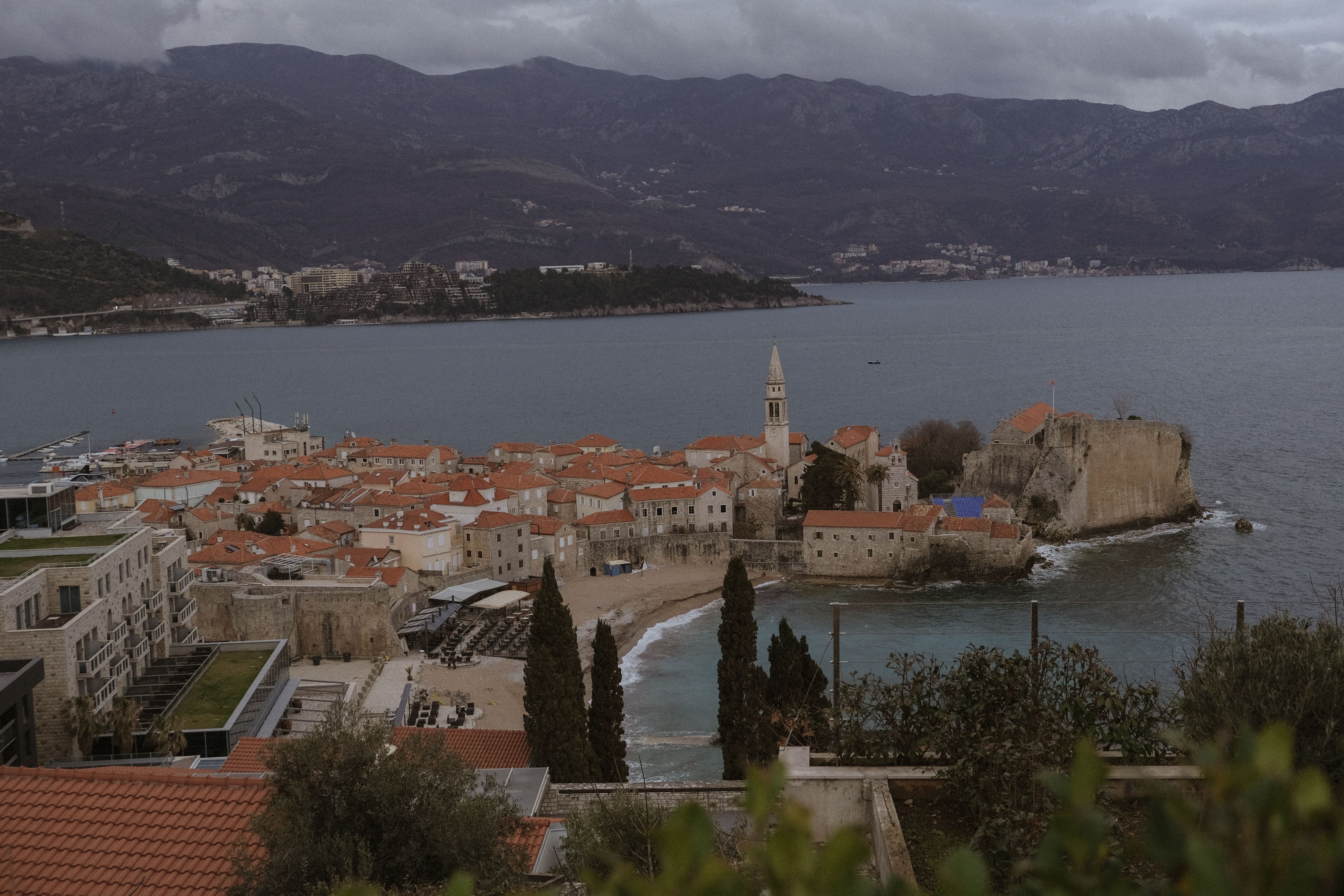 Picturesque view of Old Town Budva with Adriatic Sea and mountain backdrop. Picturesque view of Old Town Budva with Adriatic Sea and mountain backdrop.