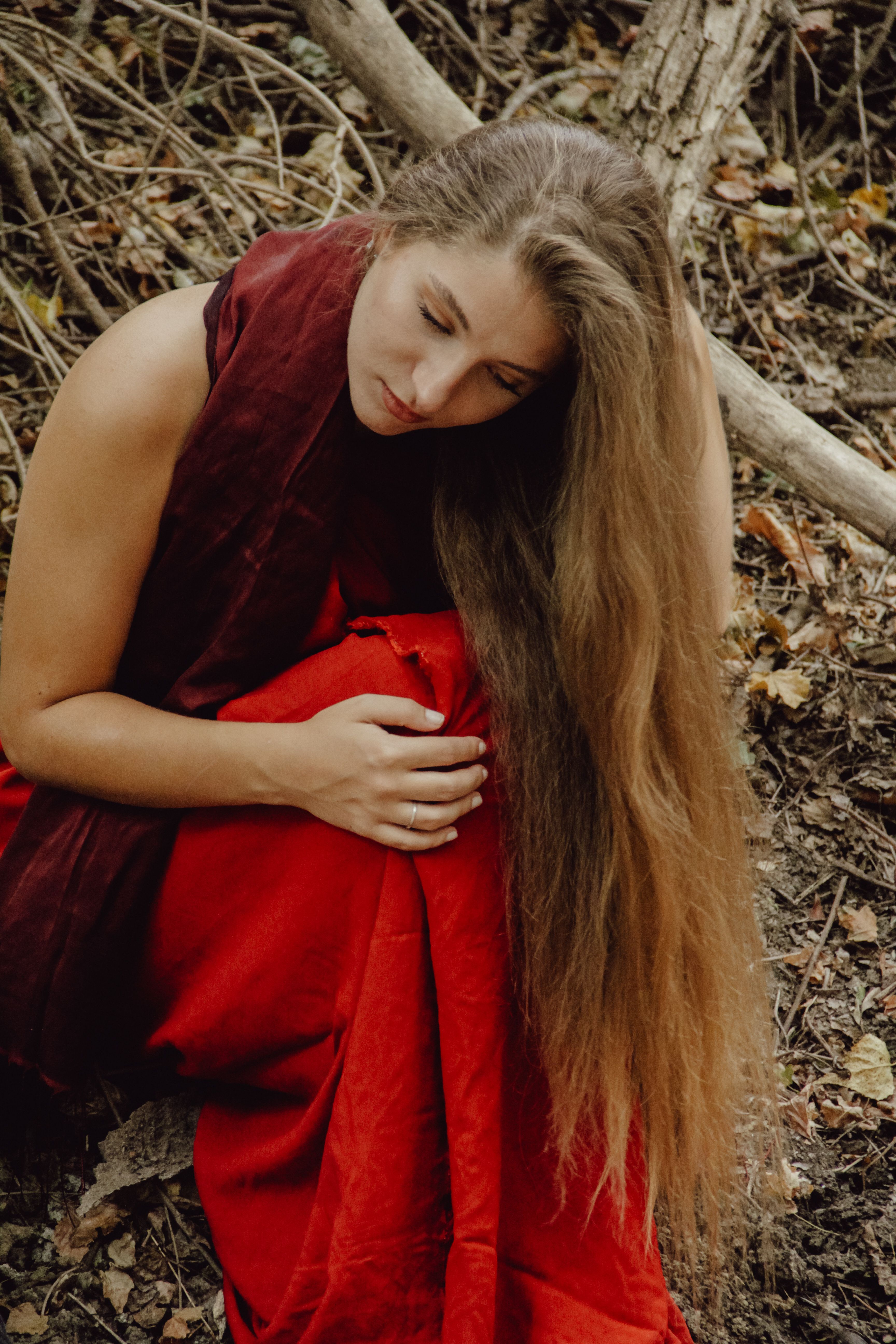 Woman in Red Dress Sitting on Autumnal Ground · Free Stock Photo