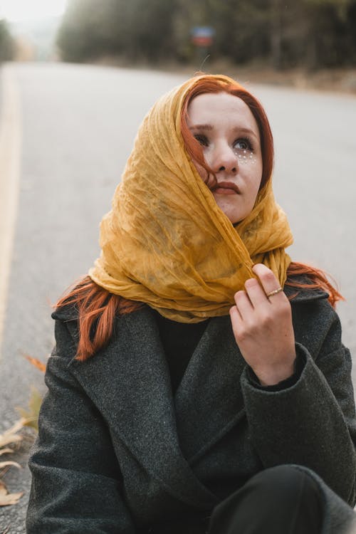 Red Haired Woman in Yellow Headscarf and Coat