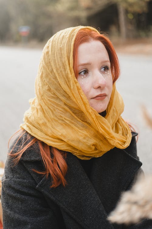 Young Woman Wearing a Coat and a Yellow Scarf 