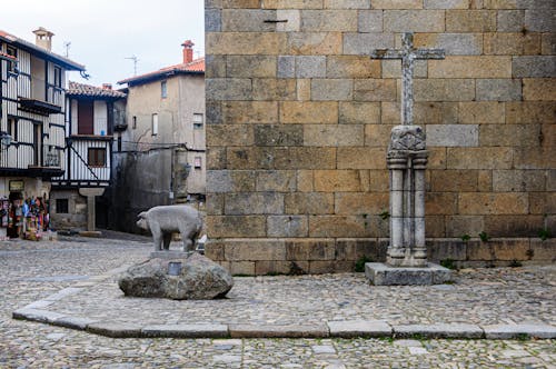 Pig and Cross Statues near Church Wall
