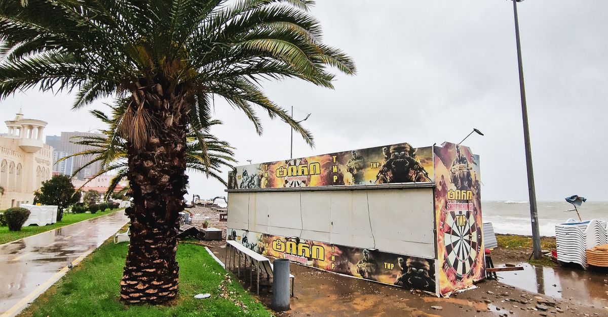 Photo by Artem Makarov Street scene showing storm aftermath with palm trees and debris, showcasing nature's power.