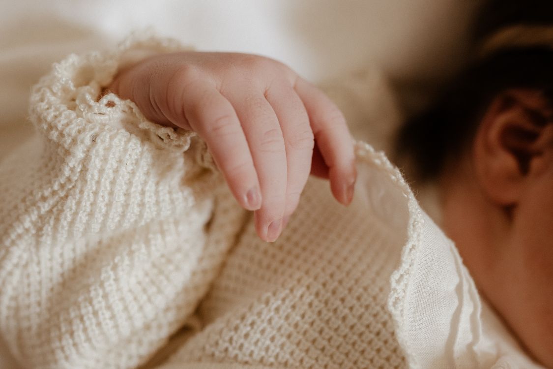 Gentle touch on baby's delicate head