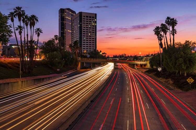 Lights On Highway In City At Sunset