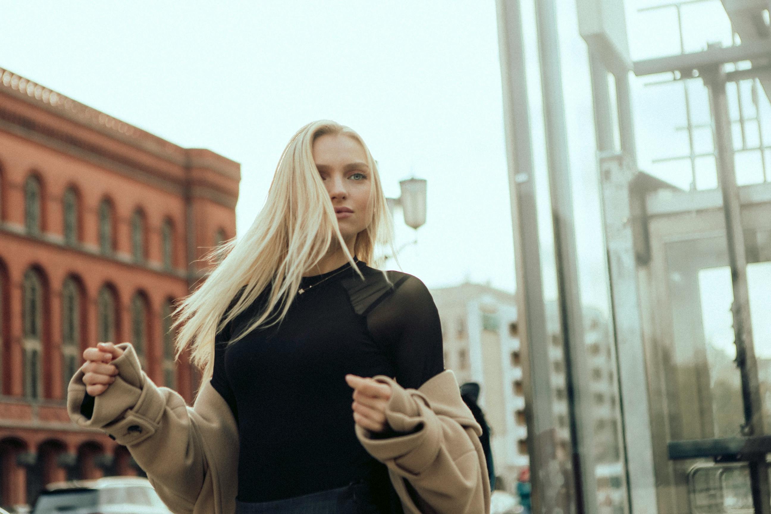 Woman in Black Clothes and Sunglasses Standing on Street · Free Stock Photo