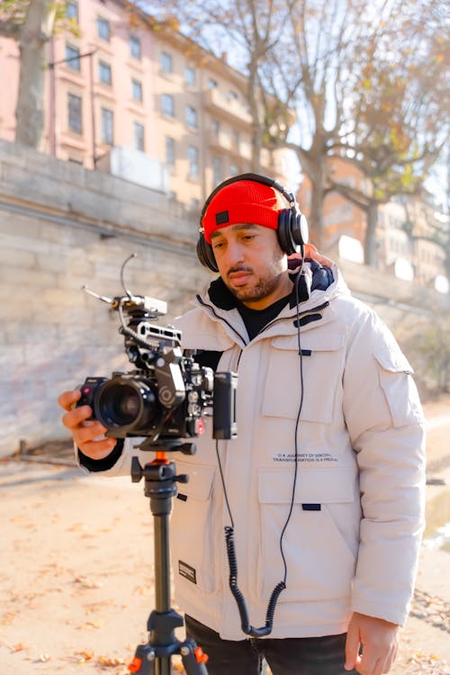 Young Man Looking at a Camera While Filming