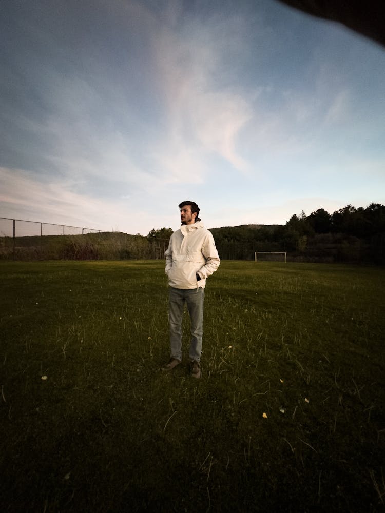 Man Standing On A Soccer Pitch