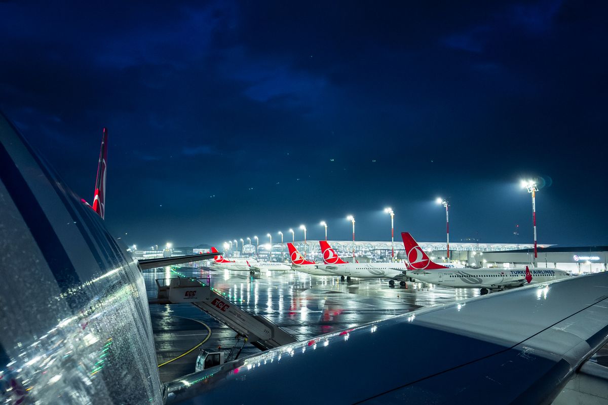 Airport apron and terminal lit after dark