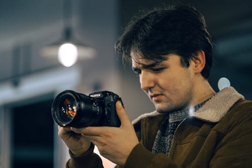 Portrait of a Young Man Using a Camera