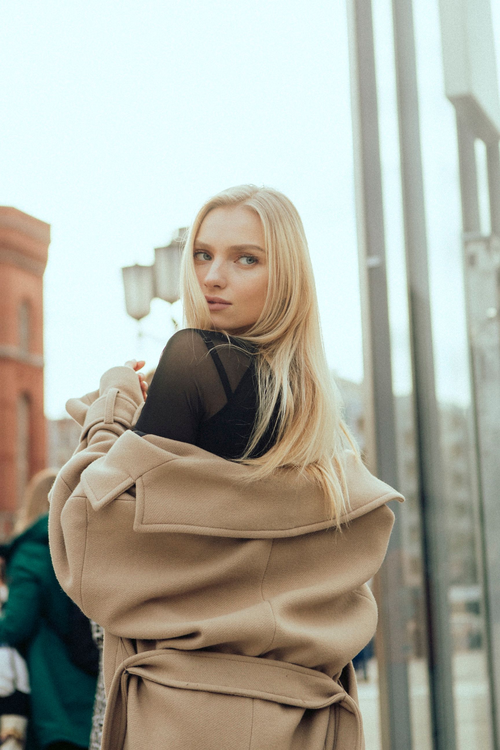 Fashionable young woman posing outdoors in Berlin, embracing autumn style.