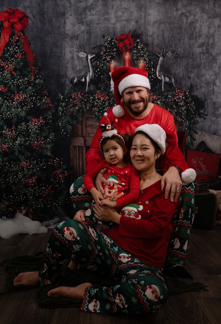 Smiling Family In Christmas Pajamas