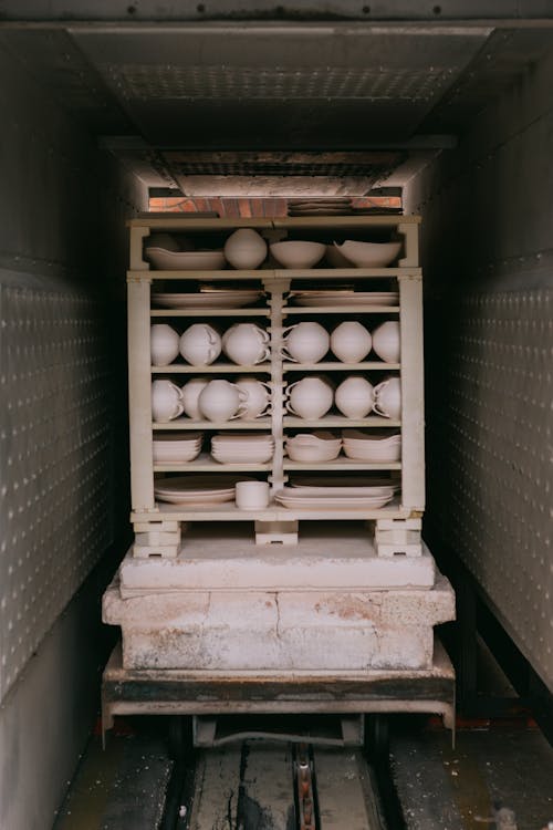 Ceramic Cups in Cupboard in Container