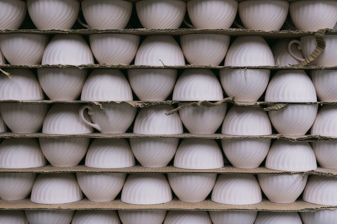 White Cups Stacked in Rows