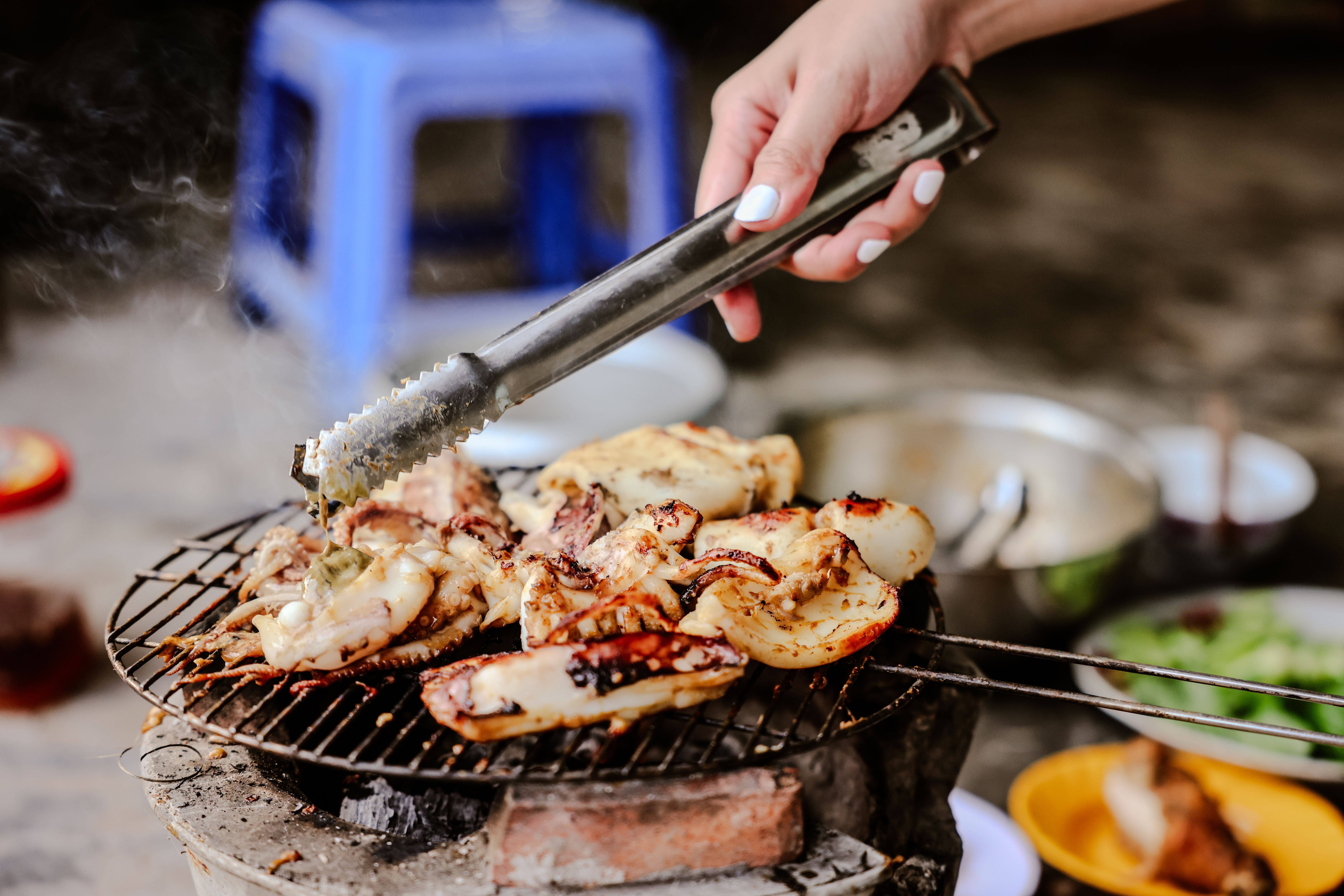 Delicious grilled chicken and seafood prepared on outdoor barbecue. Perfect outdoor meal.
