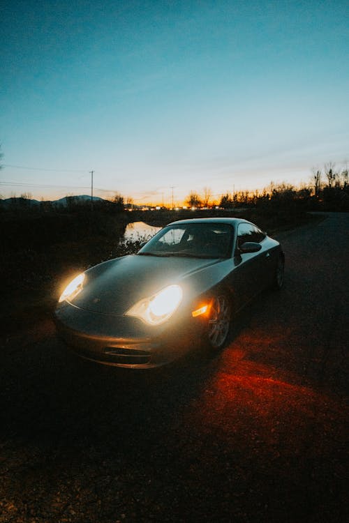 Sports Car on Road in Countryside at Sunset