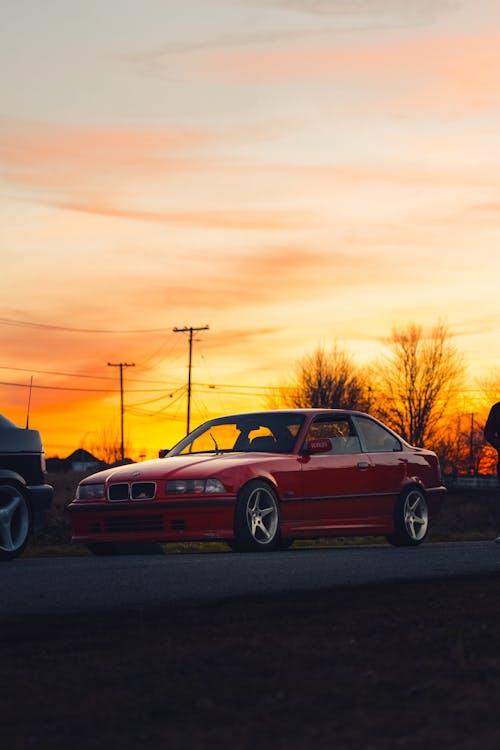 Red BMW E36 Parked on the Roadside at Sunset