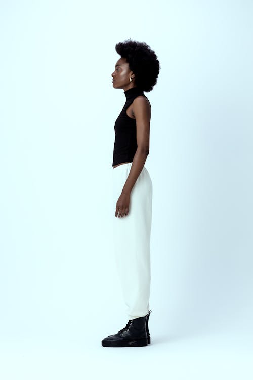 Woman with Afro Standing on White Background