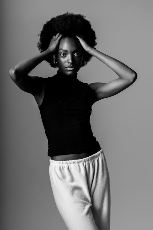 Woman Fixing Hair in Black and White