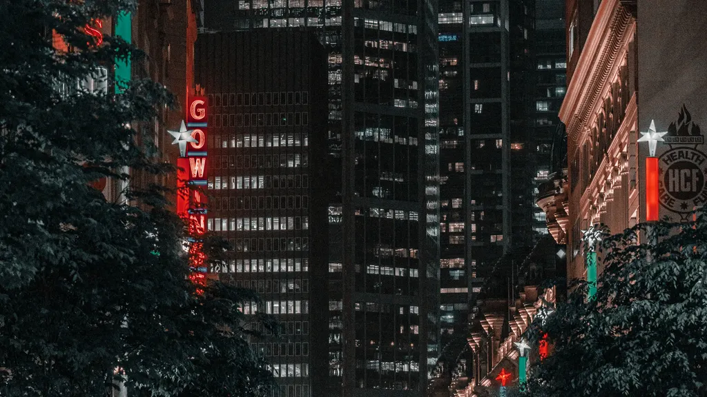 Sydney street at night with lights reflecting on wet pavement