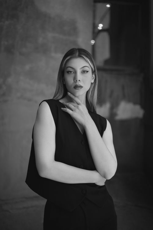 Free Black and white portrait of an elegant woman in a black dress, exuding grace and style. Stock Photo