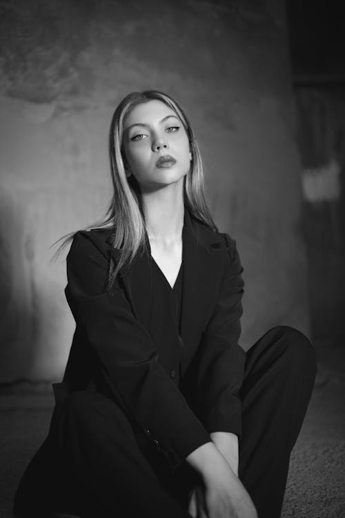 Model in an Elegant Blazer Sitting on the Ground