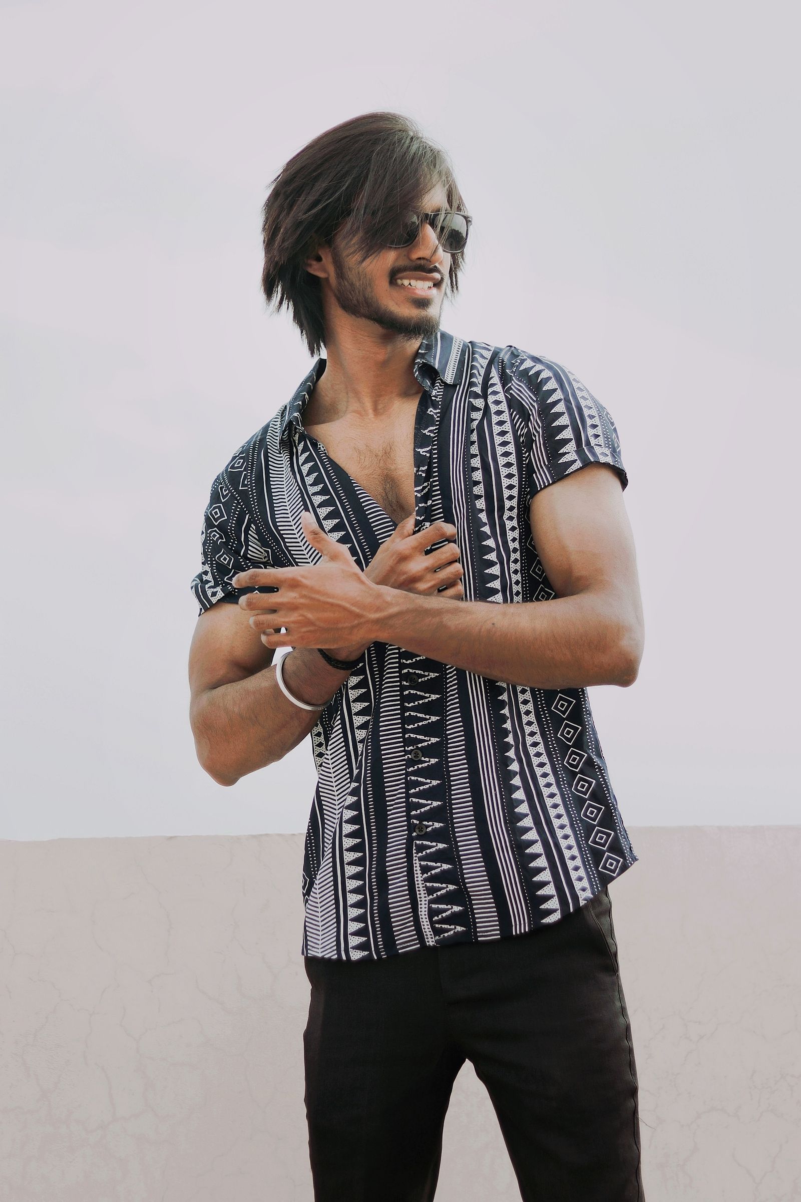 Man in sunglasses and a patterned shirt