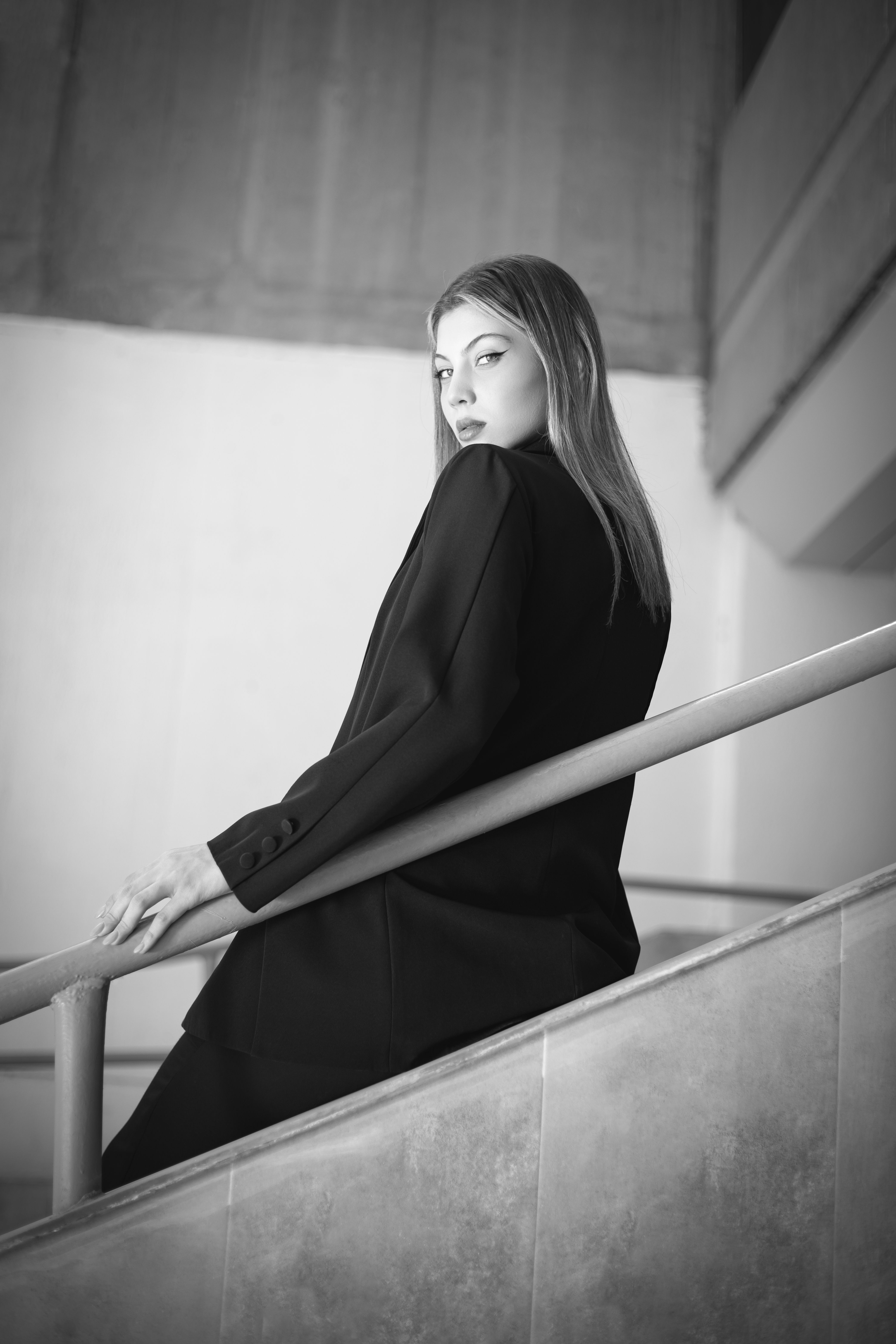 Beautiful Woman in Black Coat Posing on Stairs · Free Stock Photo