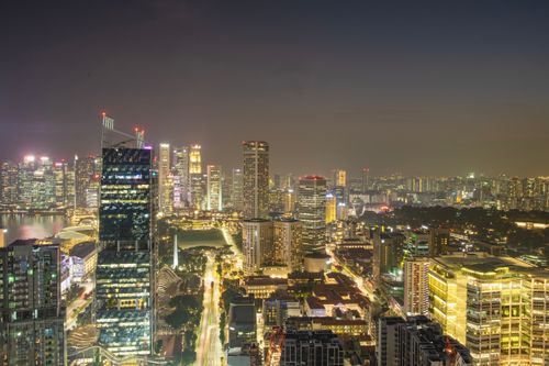 Free Captivating aerial night view of Singapore's vibrant cityscape, showcasing modern architecture and illuminated skyline. Stock Photo