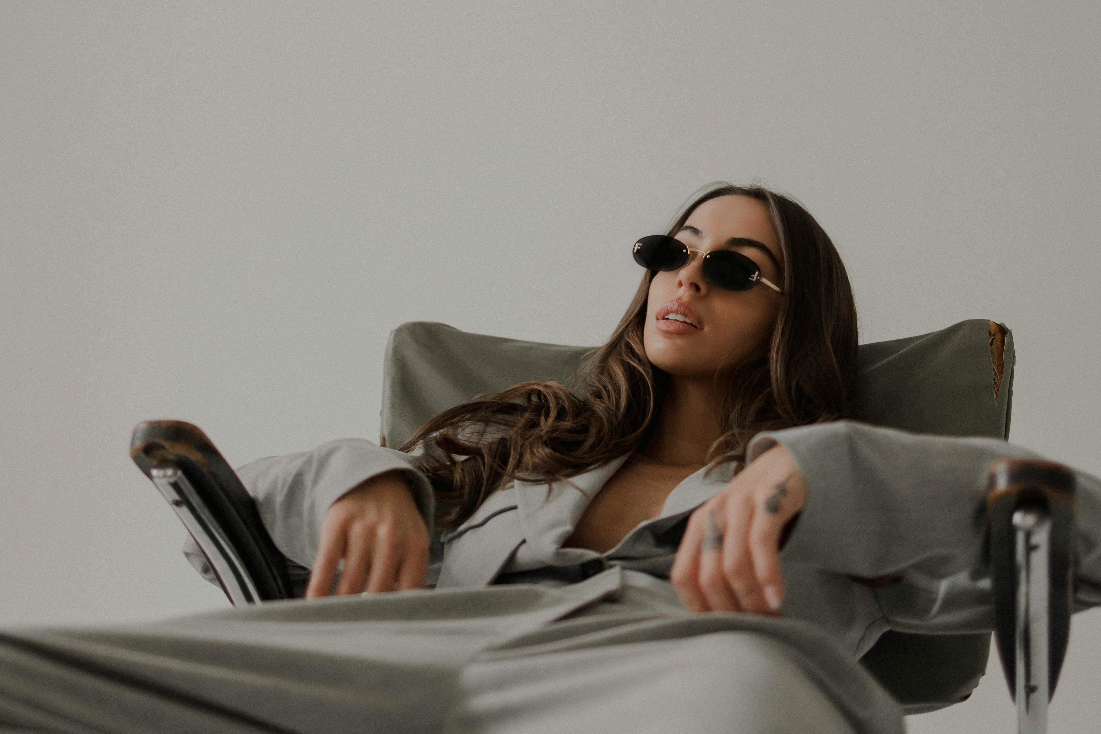 Model in a Gray Womens Suit Sprawled on an Old Ragged Chair Free