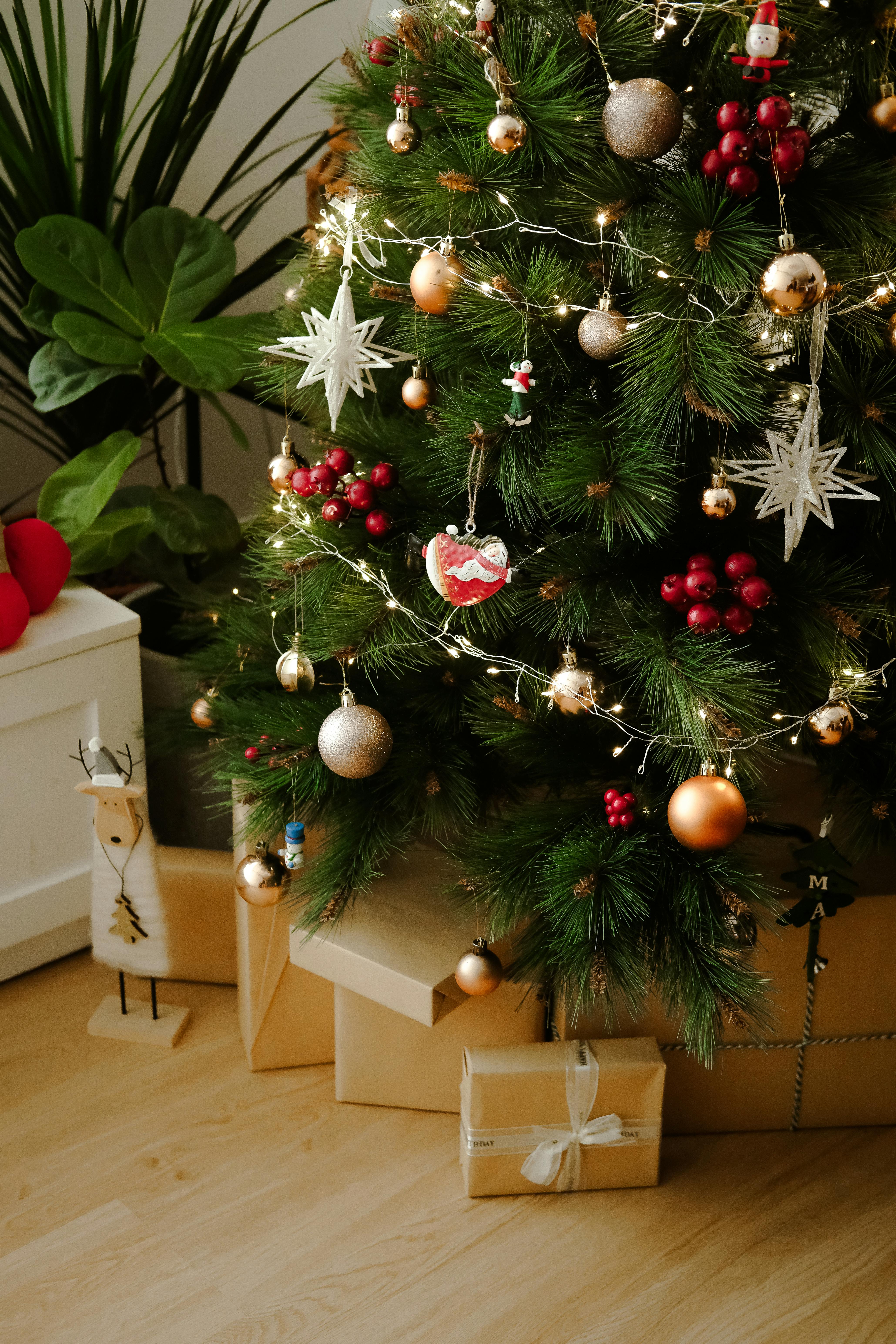 Decorated Christmas tree with gifts and ornaments, perfect for holiday ambiance.