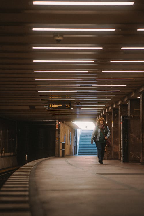 Woman Walking on the Subway Station Platform